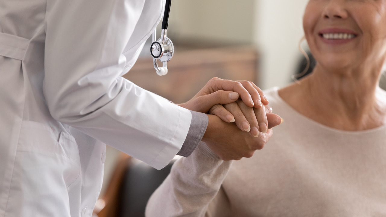 Doctor holding ladies hand at Island Health Concierge Medicine